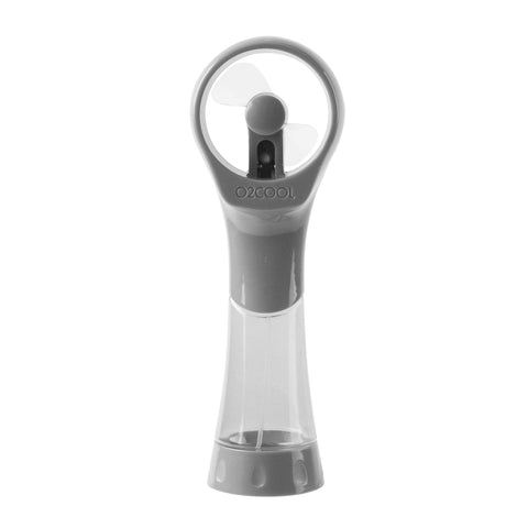 O2COOL Elite misting fan on the beach cools you while sunbathing.