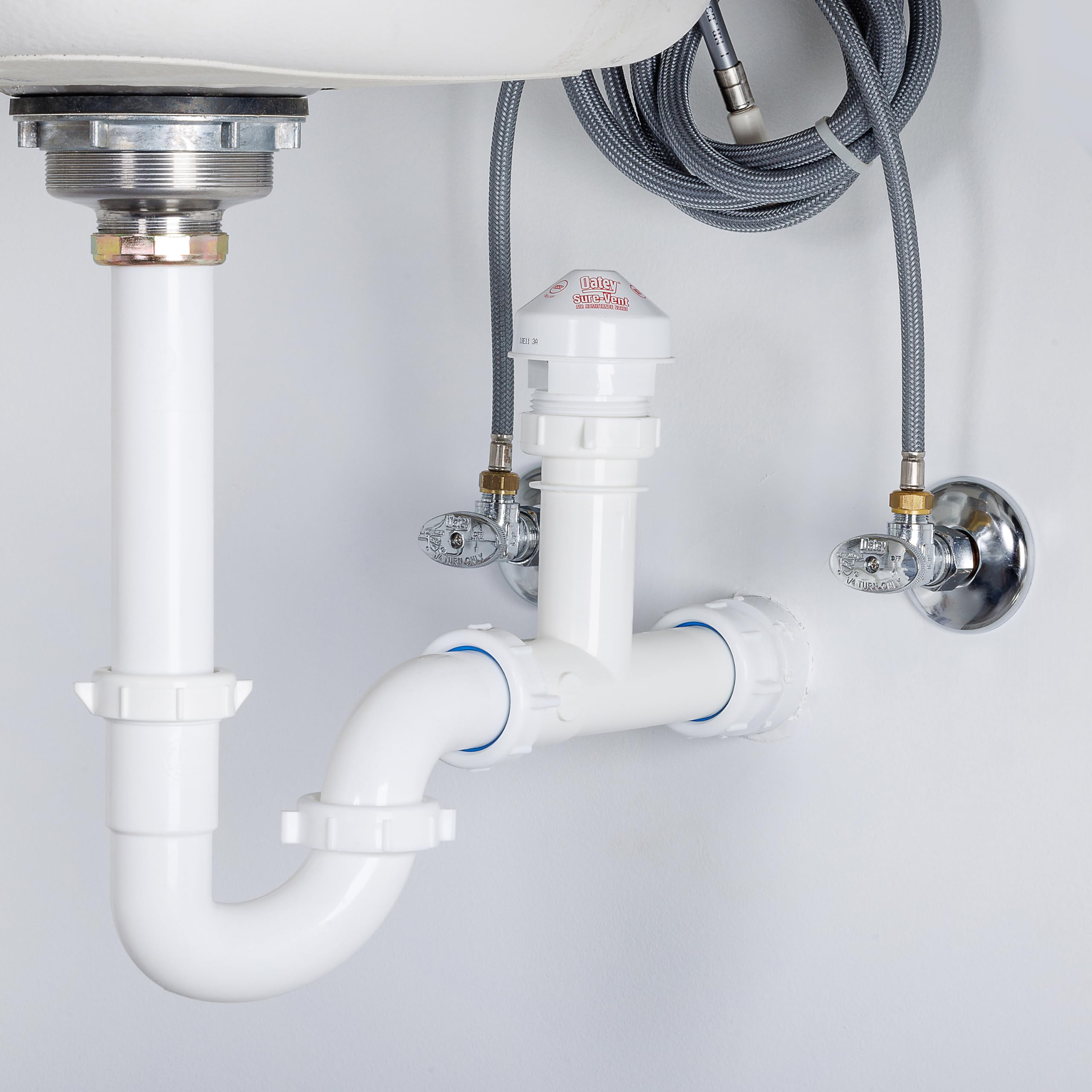 Oatey Sure-Vent valve in DWV system blocks sewer gases via pressure-aware venting