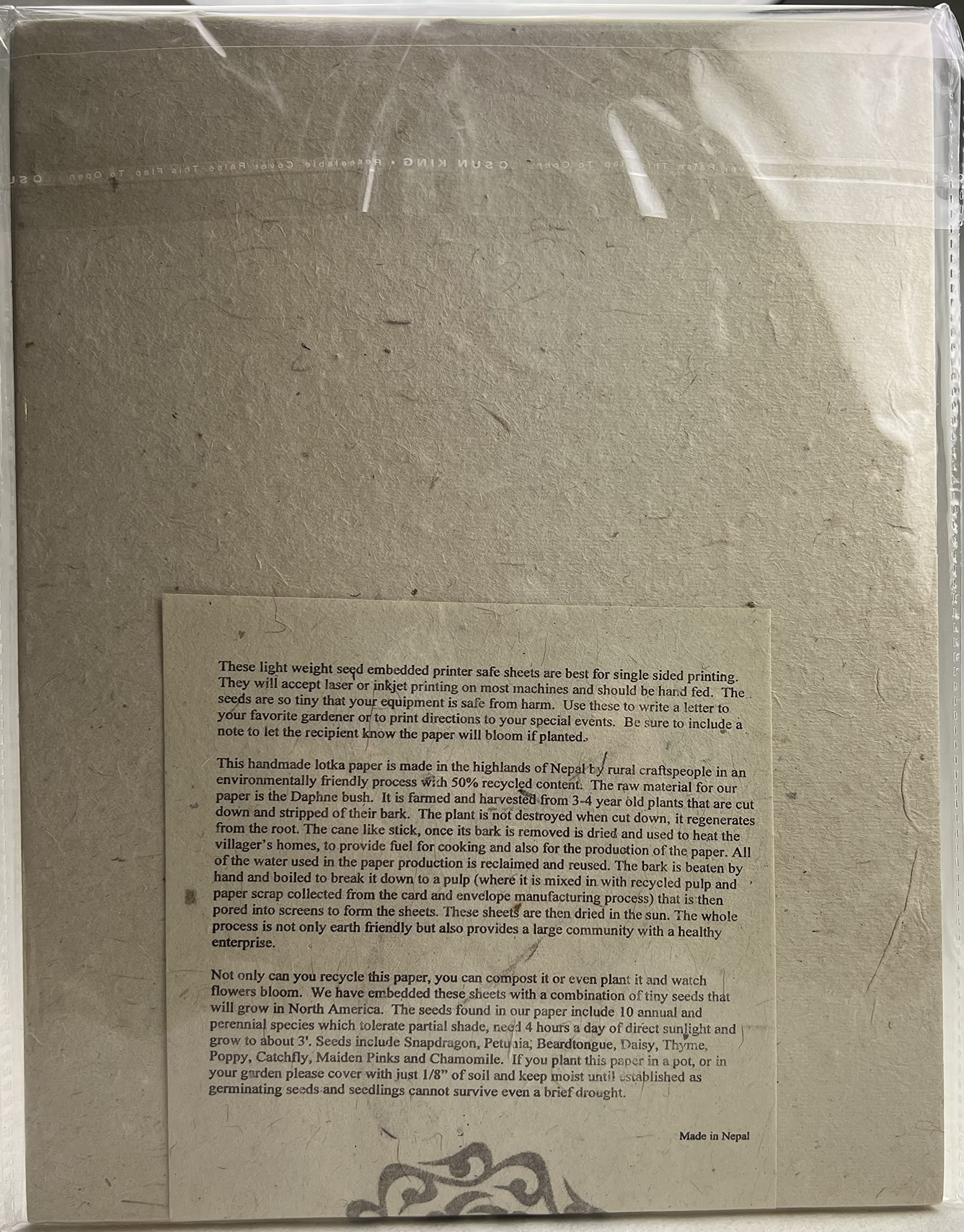 Close-up of embedded wildflower seeds in Of The Earth Lotka paper