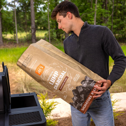 Oklahoma Joe's lump charcoal arranged for even heat using a basket or starter setup.