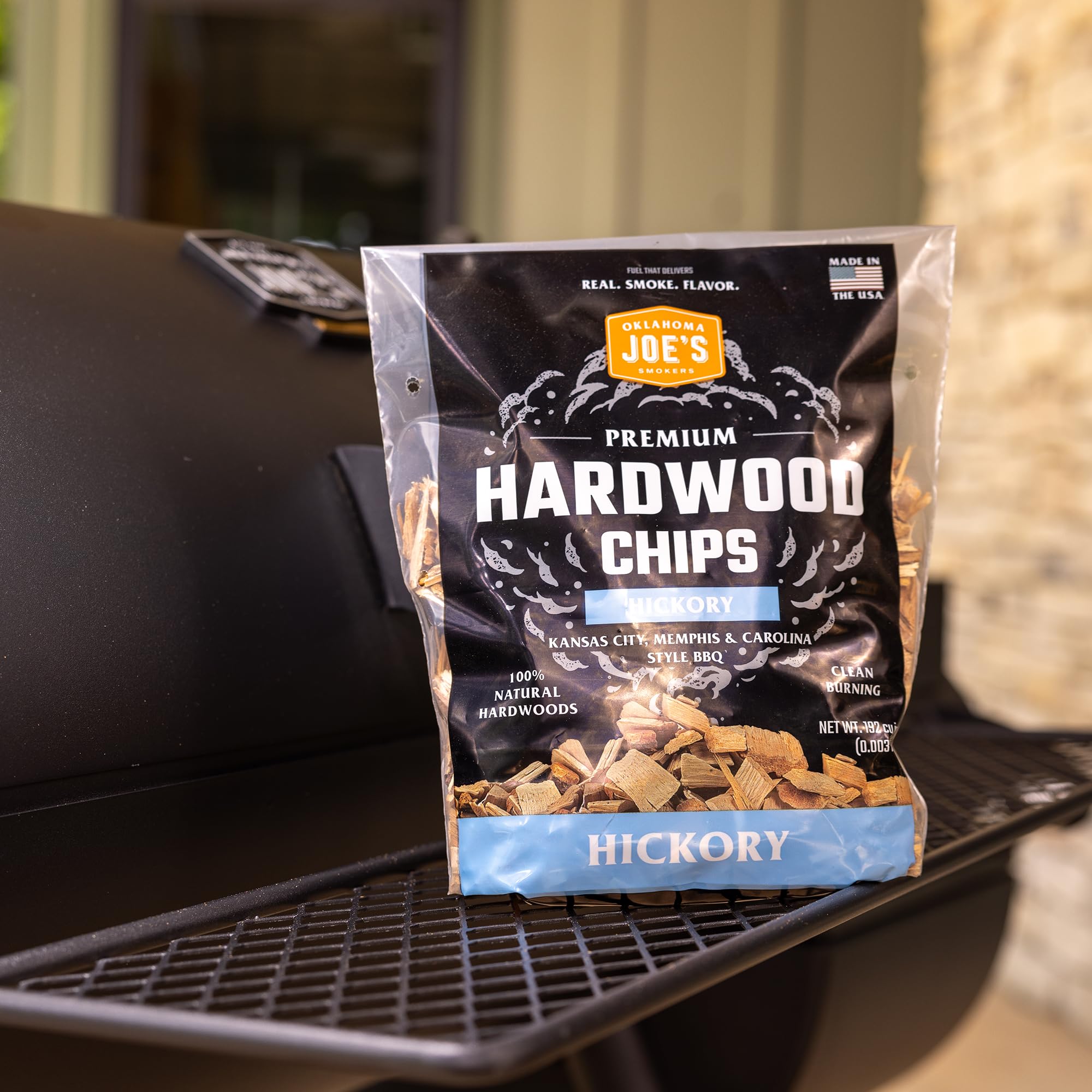 Oklahoma Joe's Hickory chips on grill for authentic smoke flavor