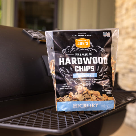 Oklahoma Joe's Hickory chips on grill for authentic smoke flavor