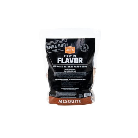 Pouring chips into a smoker box for even mesquite aroma