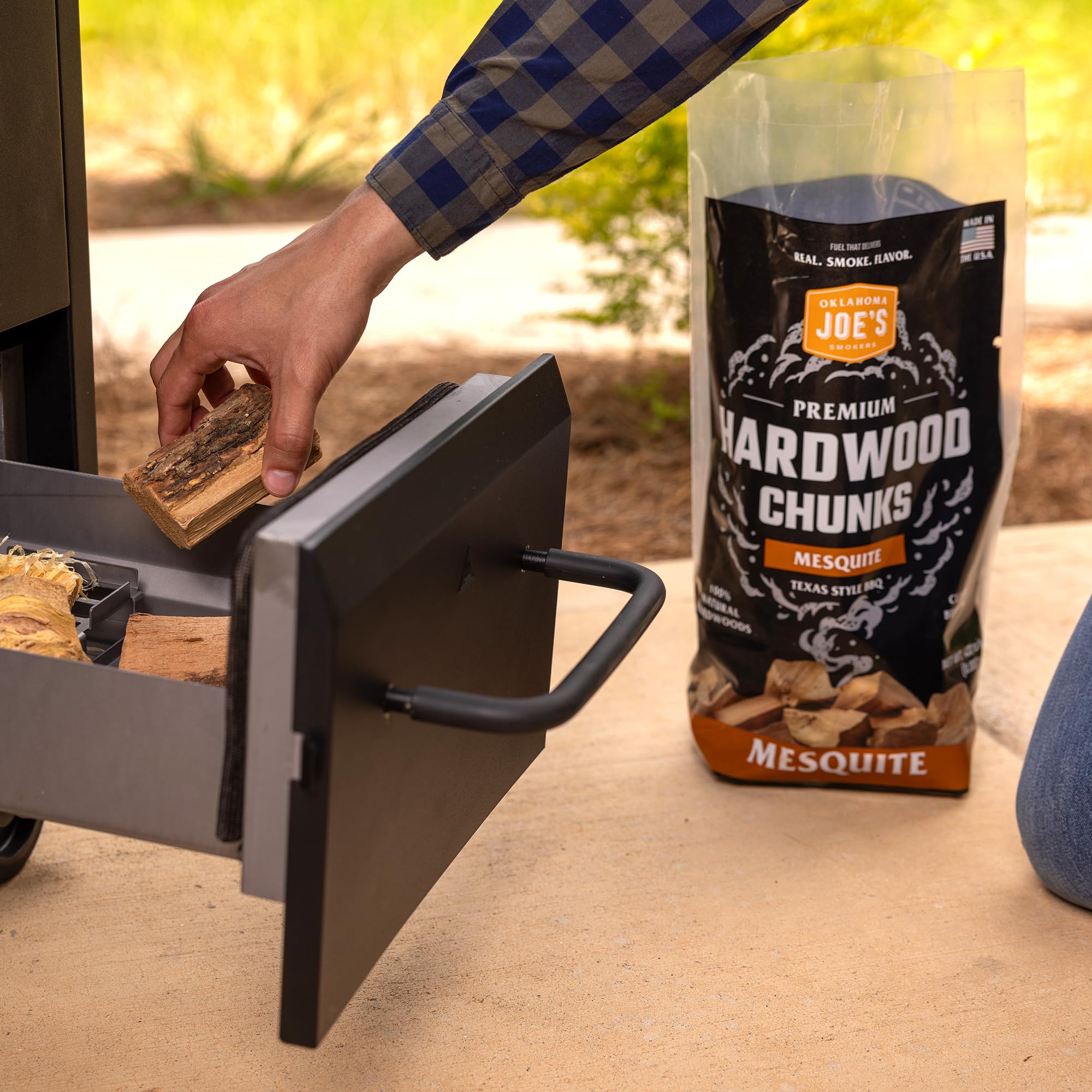 Oklahoma Joe's Mesquite Wood Chunks on coals for strong smoke flavor.