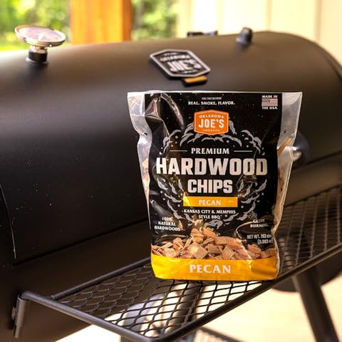 Oklahoma Joe's pecan wood chips on a grill for versatile smoke setup