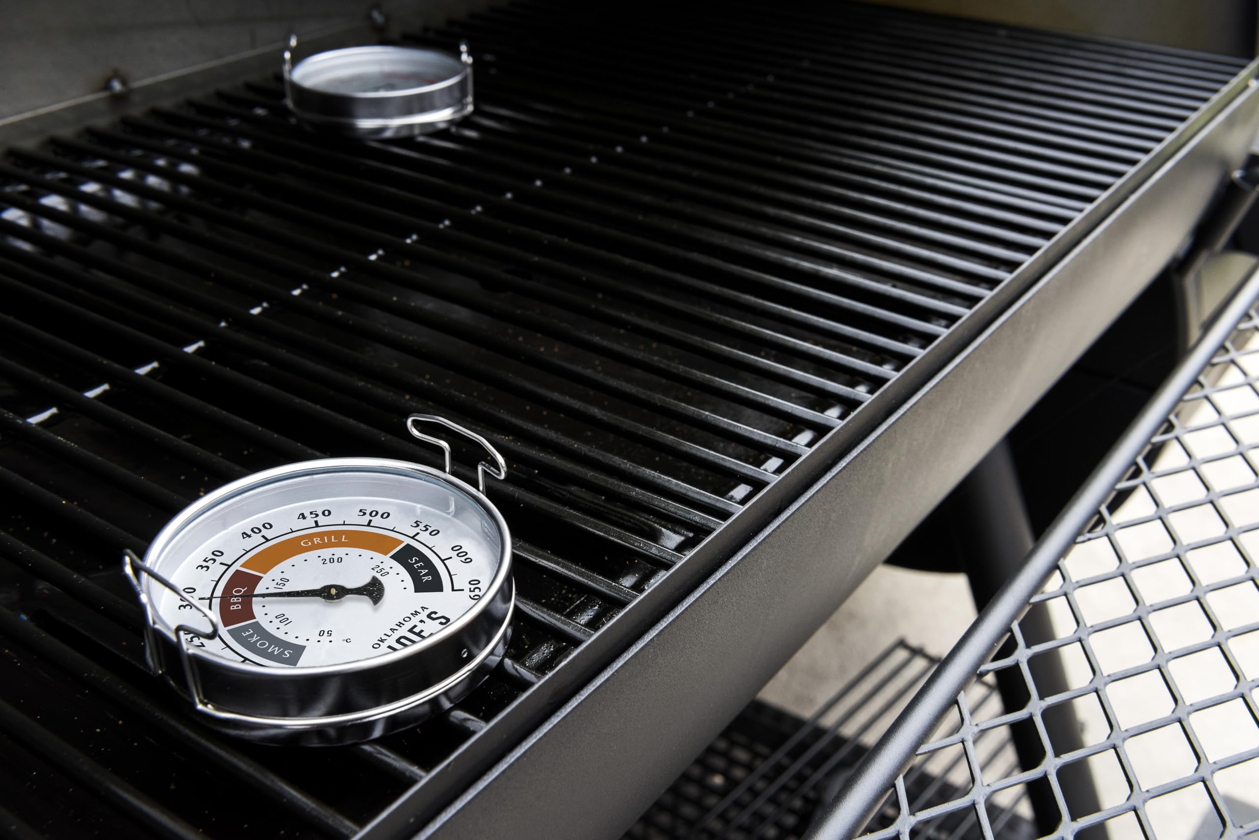 Oklahoma Joe's two gauges showing temperature markings for cooking styles