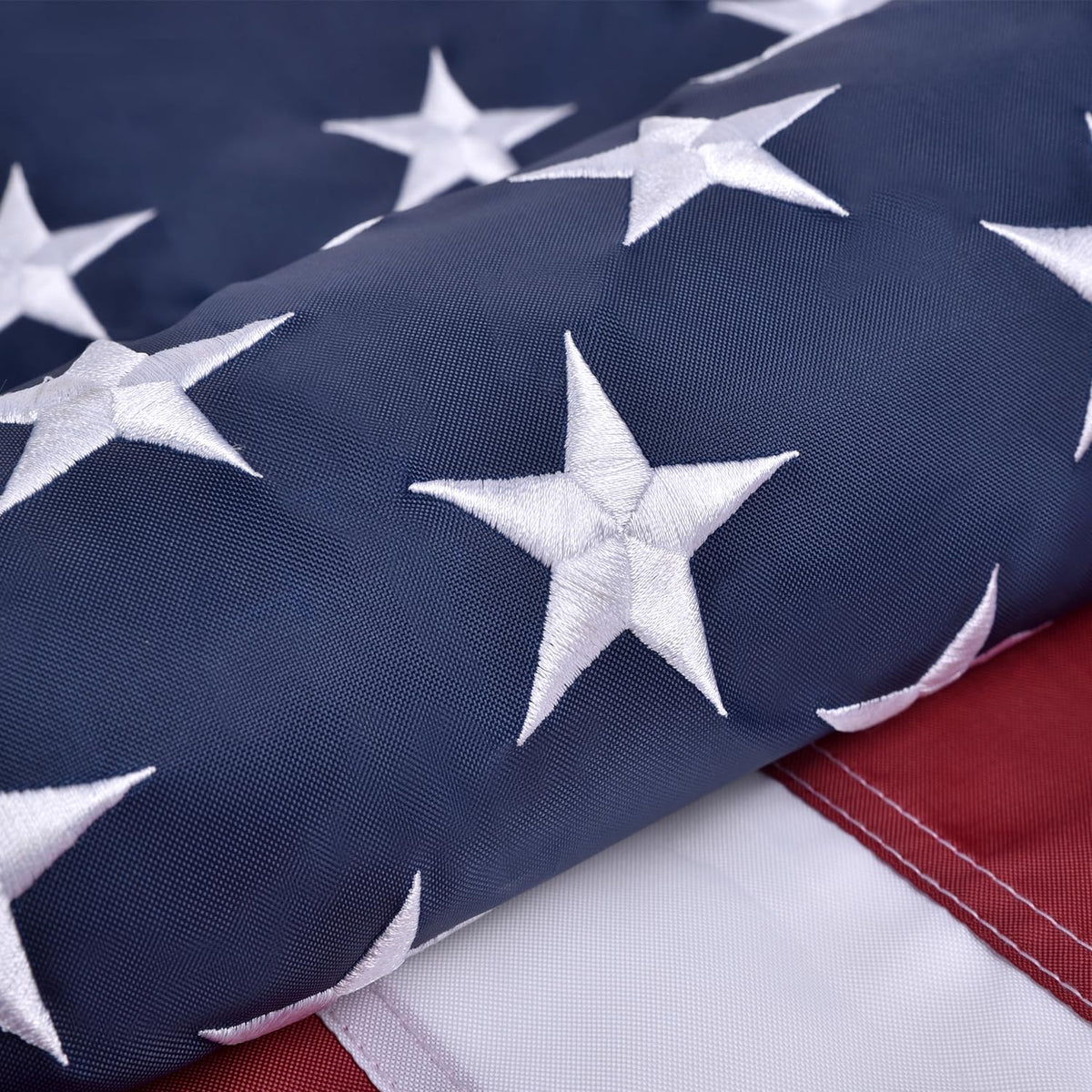 Olynese American Flag with embroidered stars for outdoor display.