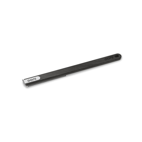 Ooni stainless bristle brush targets pizza stone debris and flour for thorough cleaning.