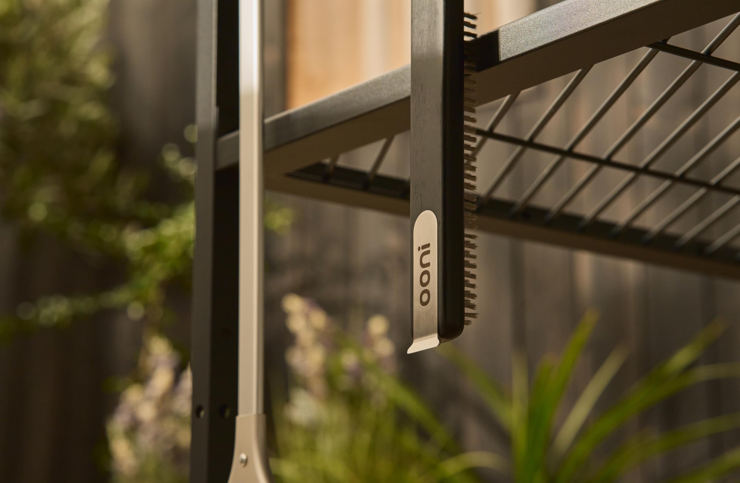 Ooni table hook-compatible design keeps the cleaner within reach on outdoor setup.