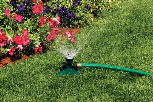 Orbit Cyclone II sprinkler in use over a lawn demonstrates easy hose attachment