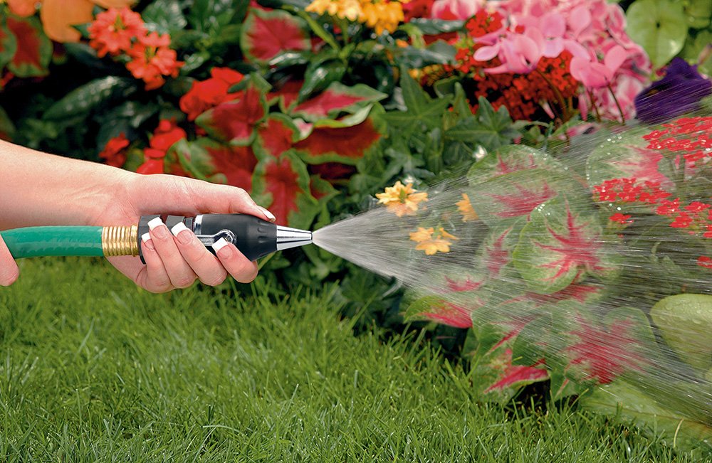 Orbit SunMate hose-end attached to hose for patio cleaning and debris removal.