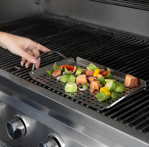 Outset grill toppers with built-in handles on a hot grill for easy lifting
