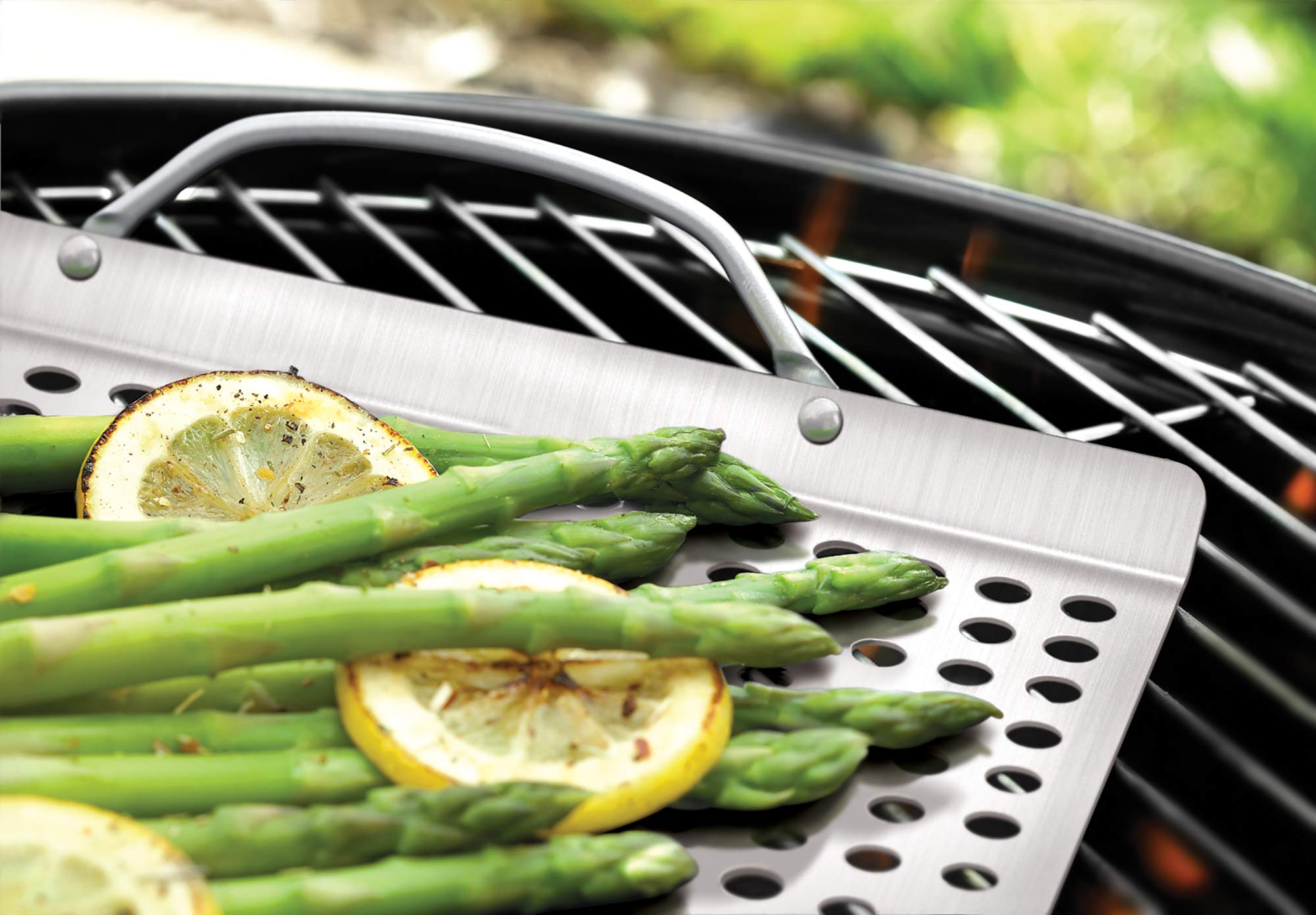 Outset stainless steel grill grid close-up shows perforated surface for even airflow.