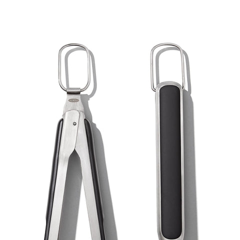 OXO Good Grips tool rest with integrated tong holder for one-handed use.