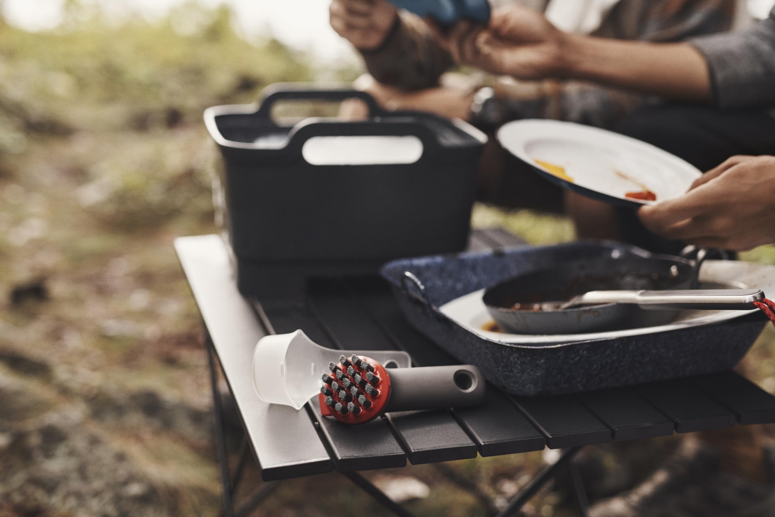 OXO brush cover doubles as a scoop for camping cleanup.