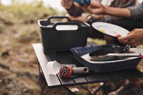 OXO brush cover doubles as a scoop for camping cleanup.
