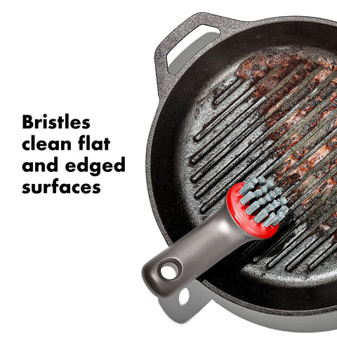 OXO Outdoor Heavy Duty Brush cleaning flat cookware surfaces.