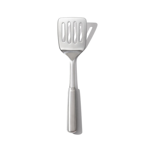 OXO Steel Cooking Turner head close-up showing sturdy flexibility for easy flipping.