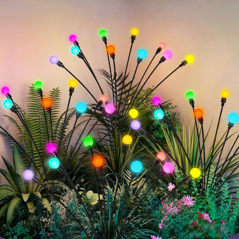 PATIOPIA solar garden lights with firefly glow lighting the yard at dusk
