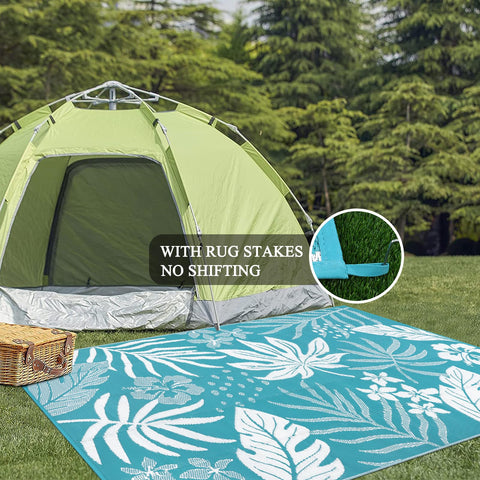 Pauwer patio scene on deck with teal floral rug for stylish outdoor living.