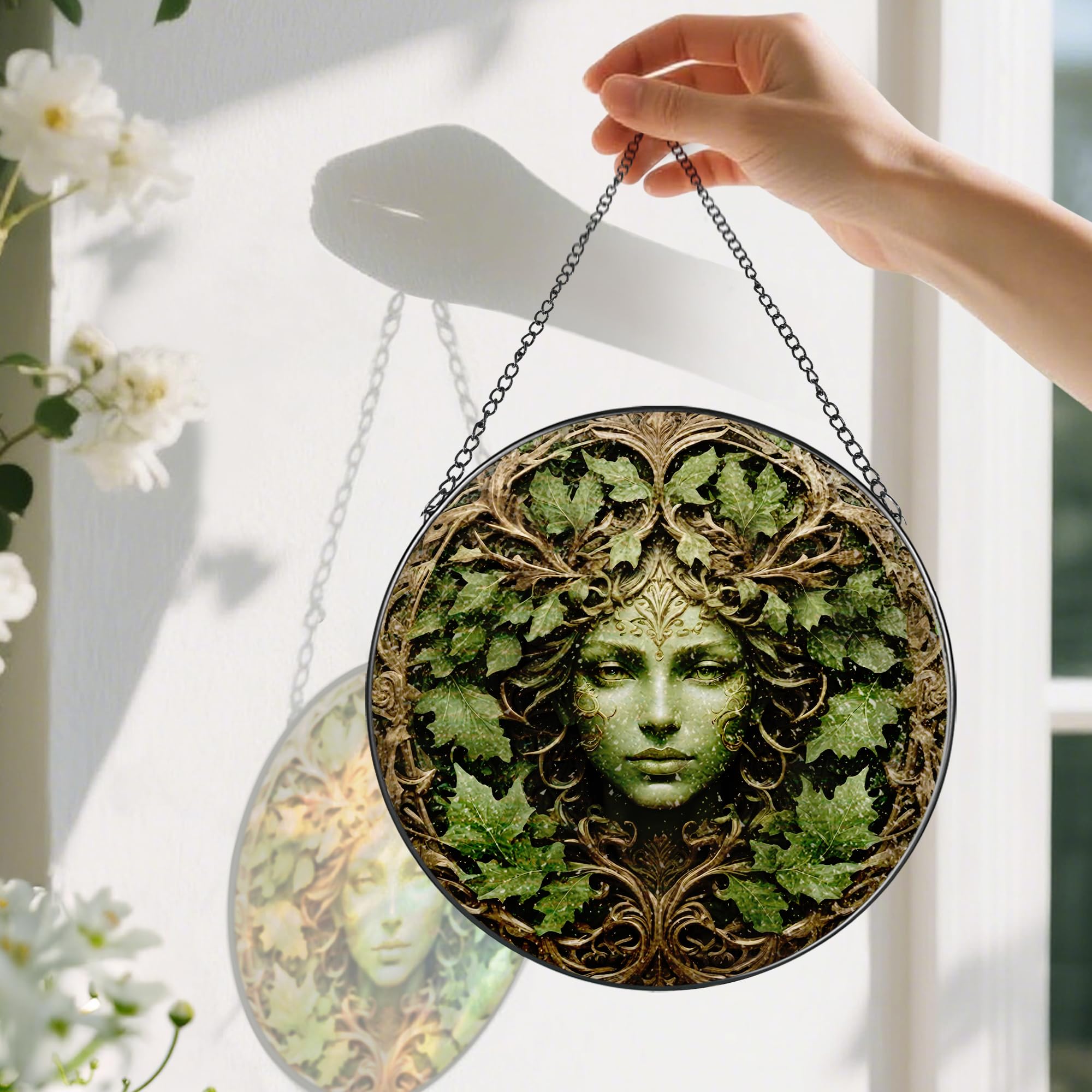 Close-up of Pauyadu Green Man suncatcher showing vivid color details in natural light