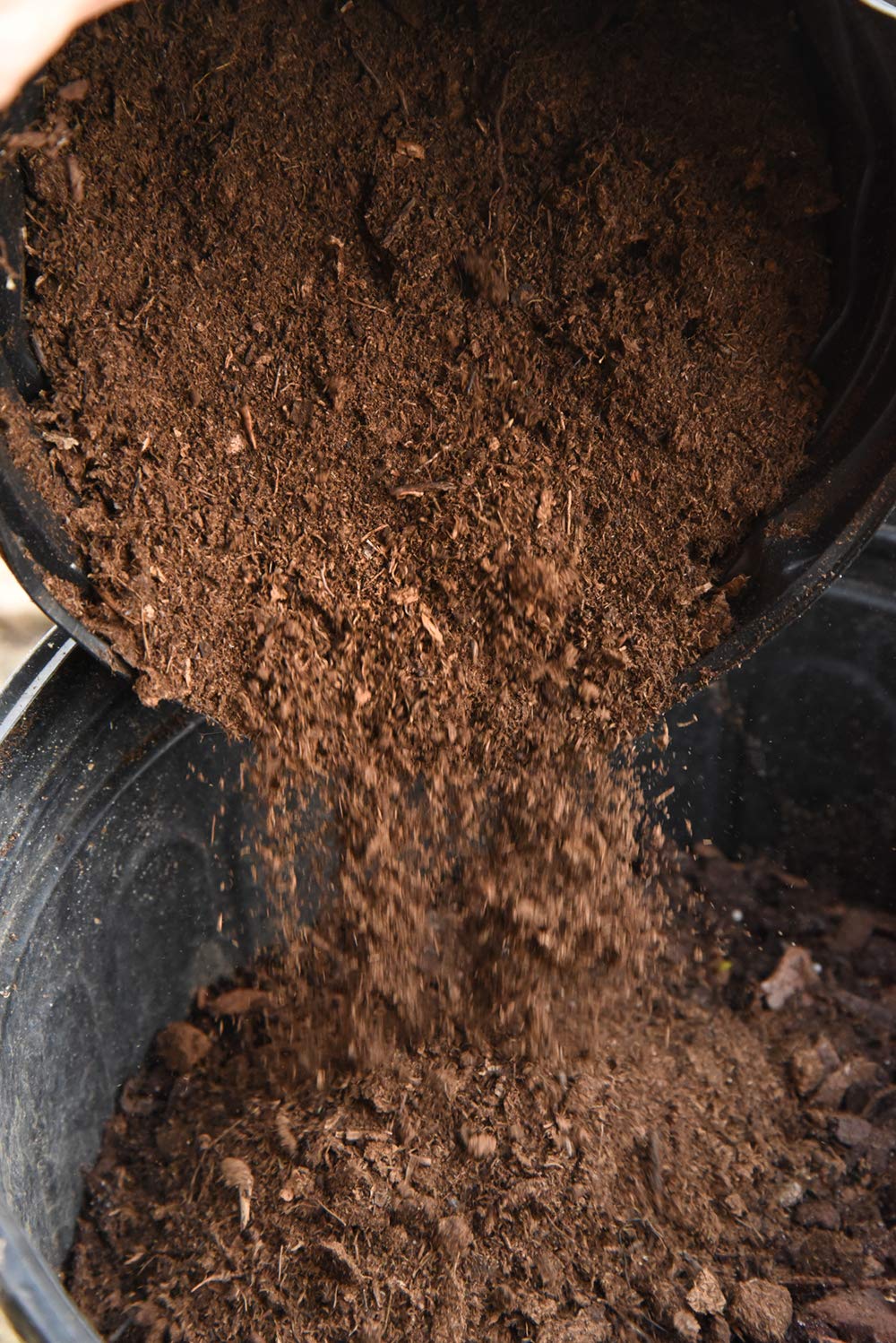 Perfect Plants peat moss being mixed into potting soil to improve moisture.