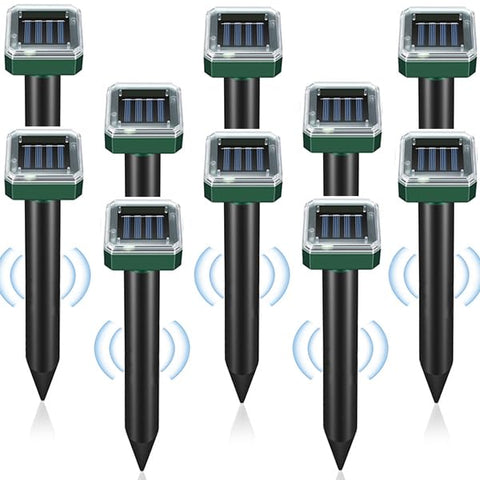 PestMentor Solar Mole Repellent Stakes protecting flower beds in bright sunlight