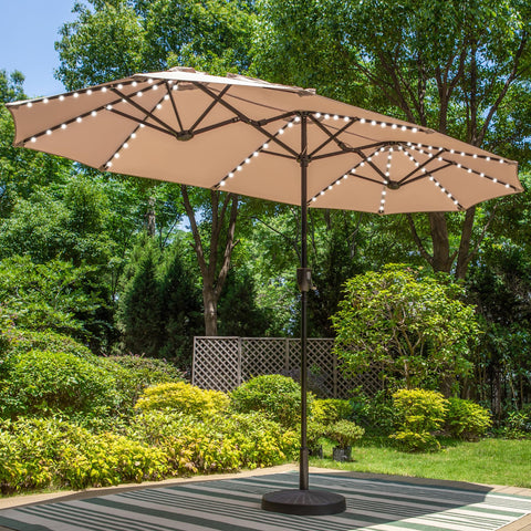 PHI VILLA 13ft triple-head beige umbrella shading a large outdoor dining area.