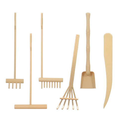Pilarmuture mini rake with stamps shown on beige sandbox for focus