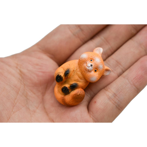 Pinenjoy red panda tongue-out figurine for playful decor.