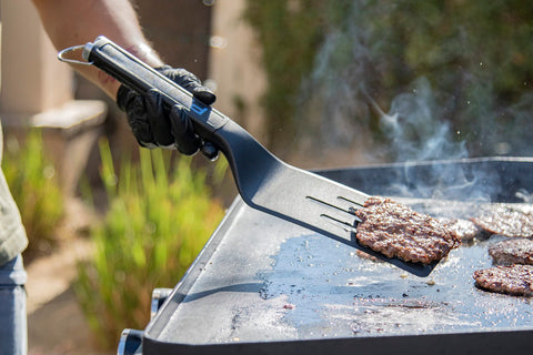 Pit Boss Ultimate griddle scraper with bottle opener end for beverages