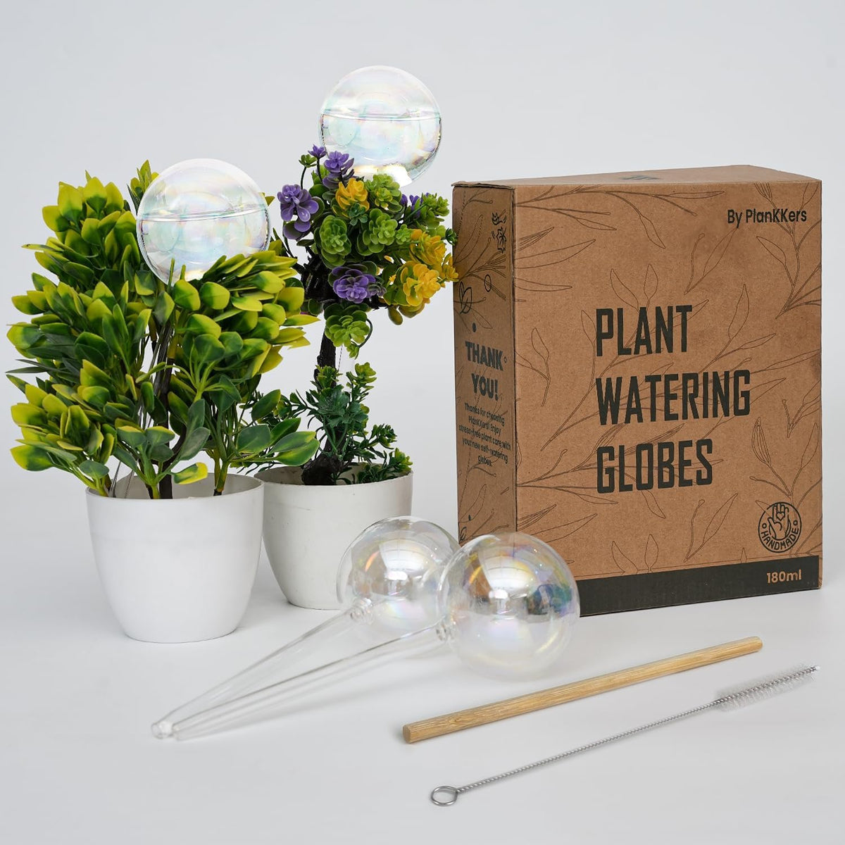 PlanKKers iridescent self-watering globe in use feeding a lush indoor plant.