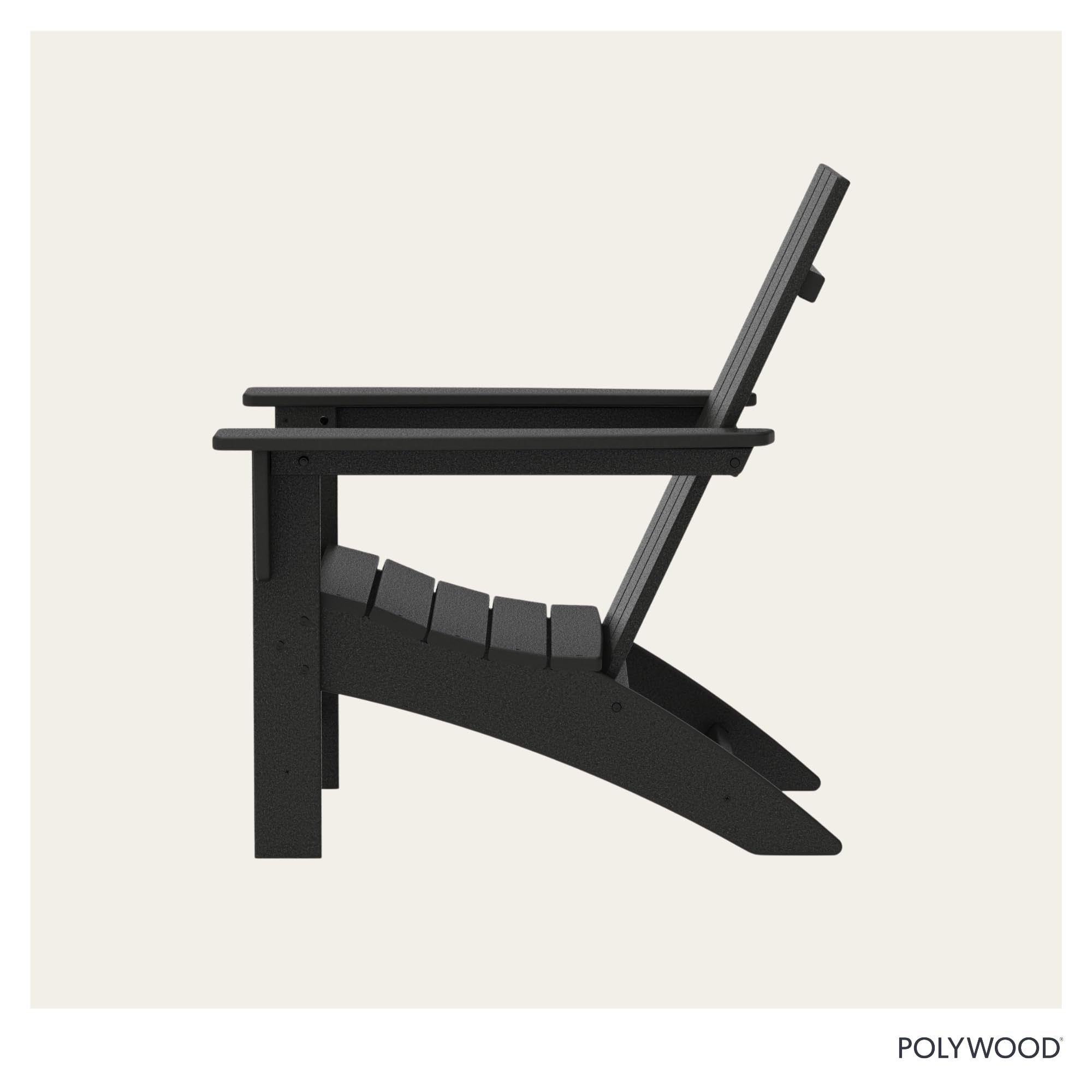 Polywood Adirondack chair in black shown near a fire pit setting for gatherings.