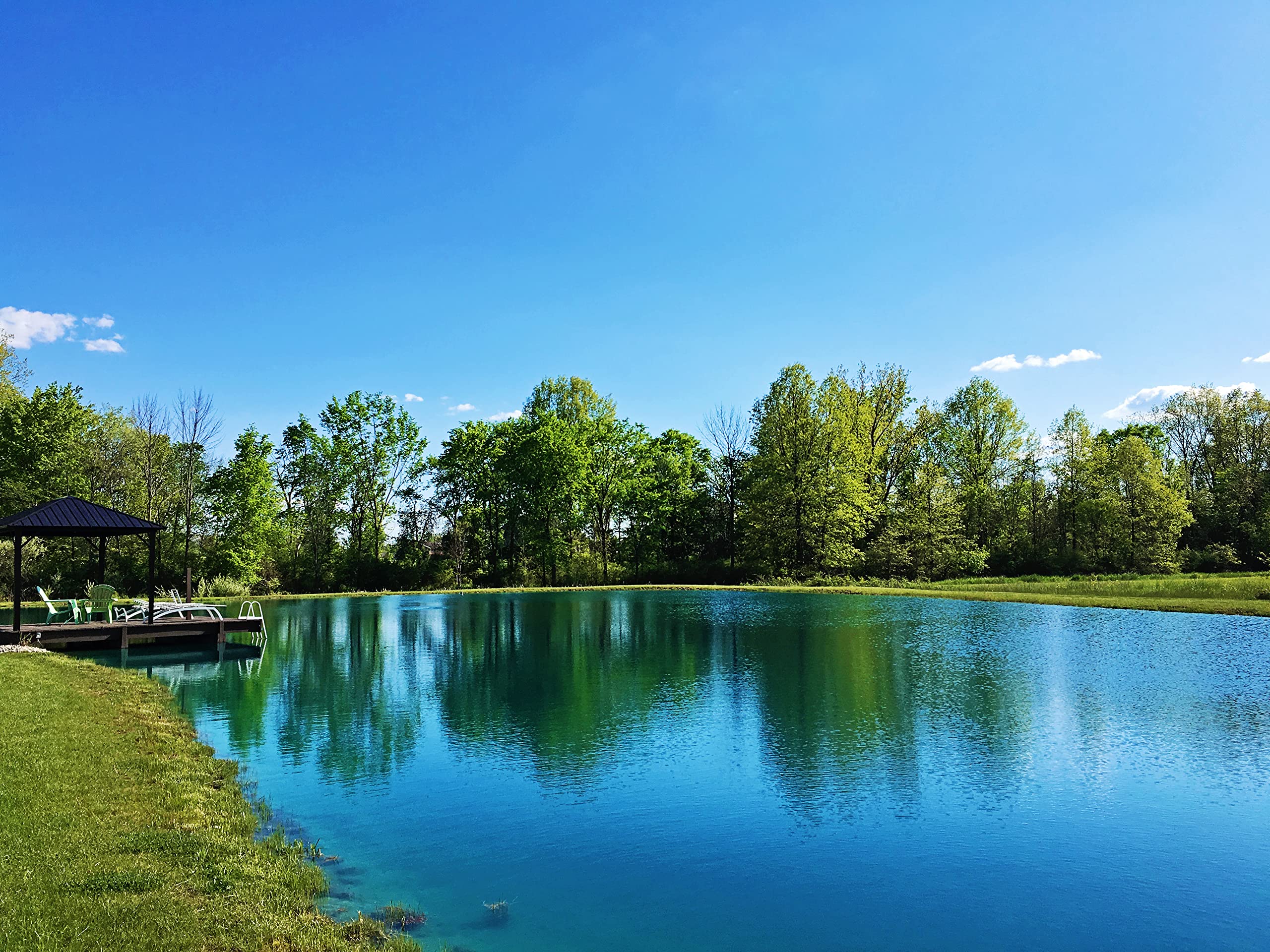 Pond Worx Blue Lake Dye being mixed into water