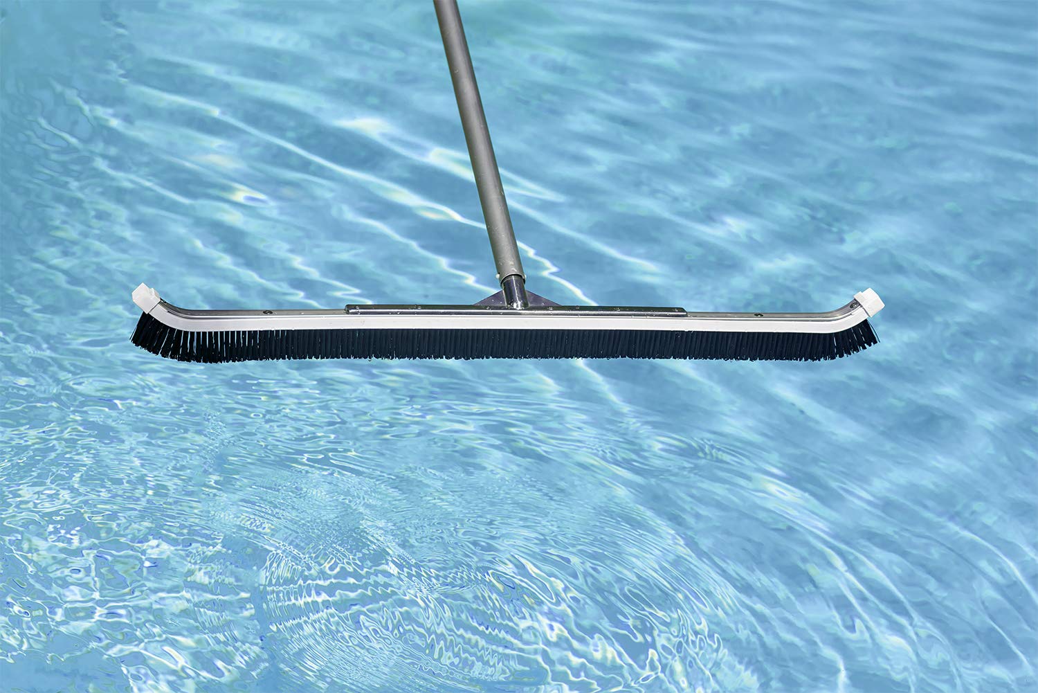 Curved head with nylon bristles increases contact with pool surfaces