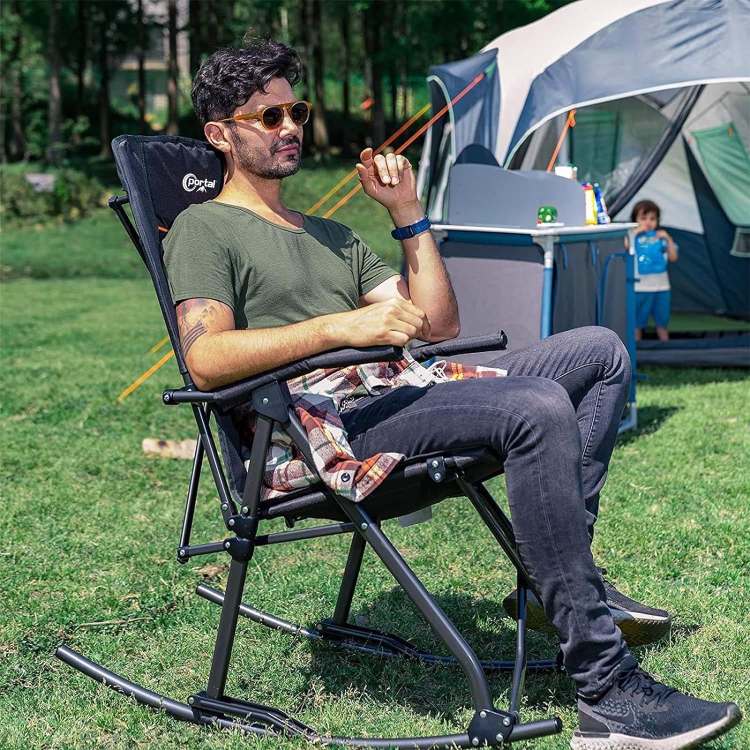 Portal Oversized Rocking Chair on a sunny campsite delivering comfortable relaxation.