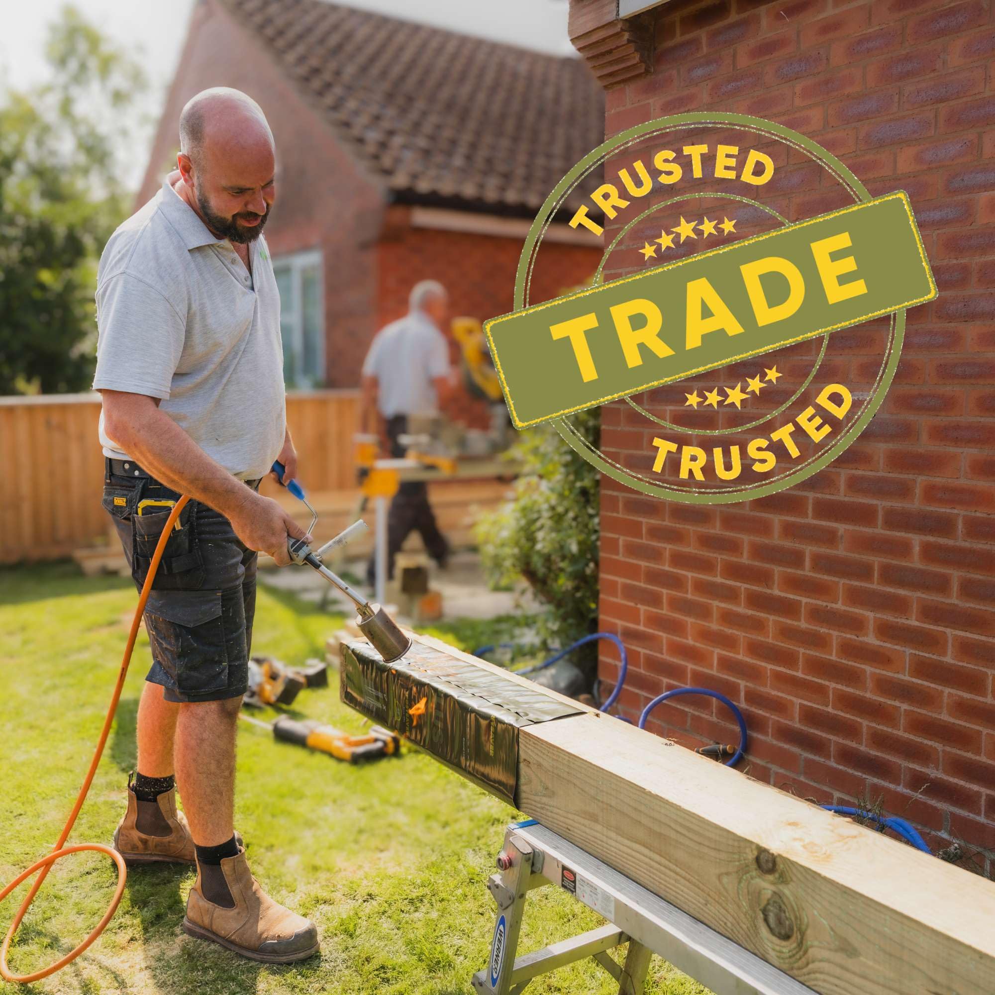Postsaver Pro-Wrap Large sleeve in use, protecting a fence post during assembly.