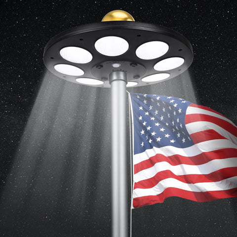 PPQ Solar Flag Pole Light front view with bright flag illumination at night