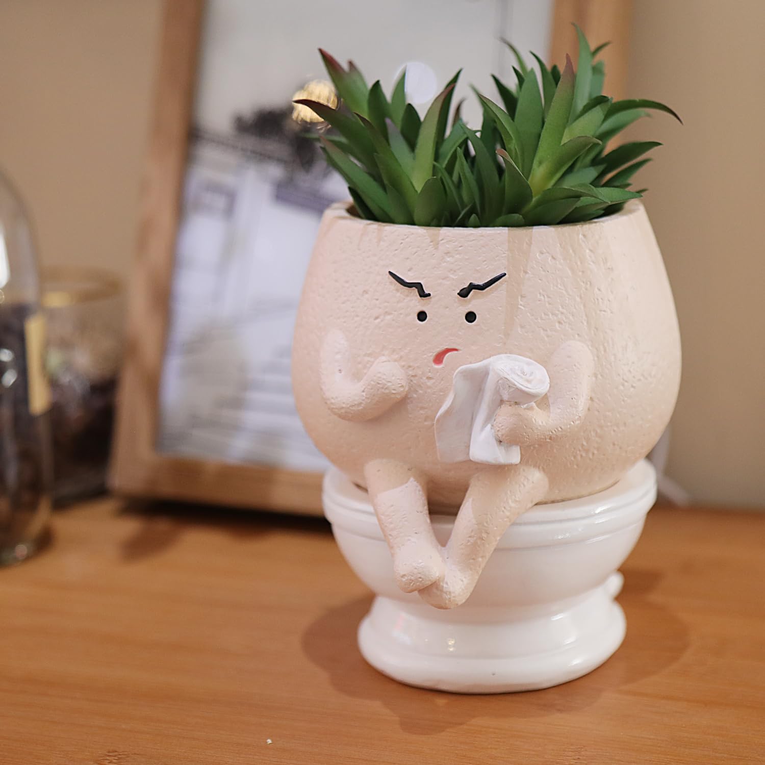 Pricetail face planter on toilet adds humorous charm for home or office decor.
