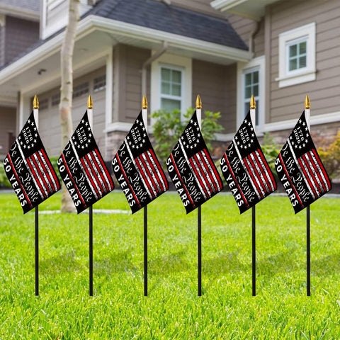 Probsin outdoor flag display on lawn creating a festive backdrop
