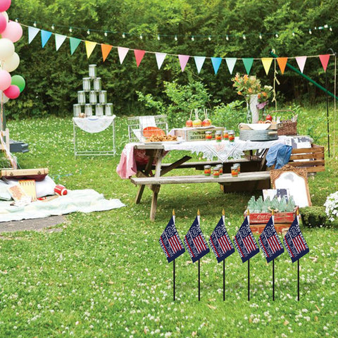Probsin flags line a garden path for outdoor ambiance.
