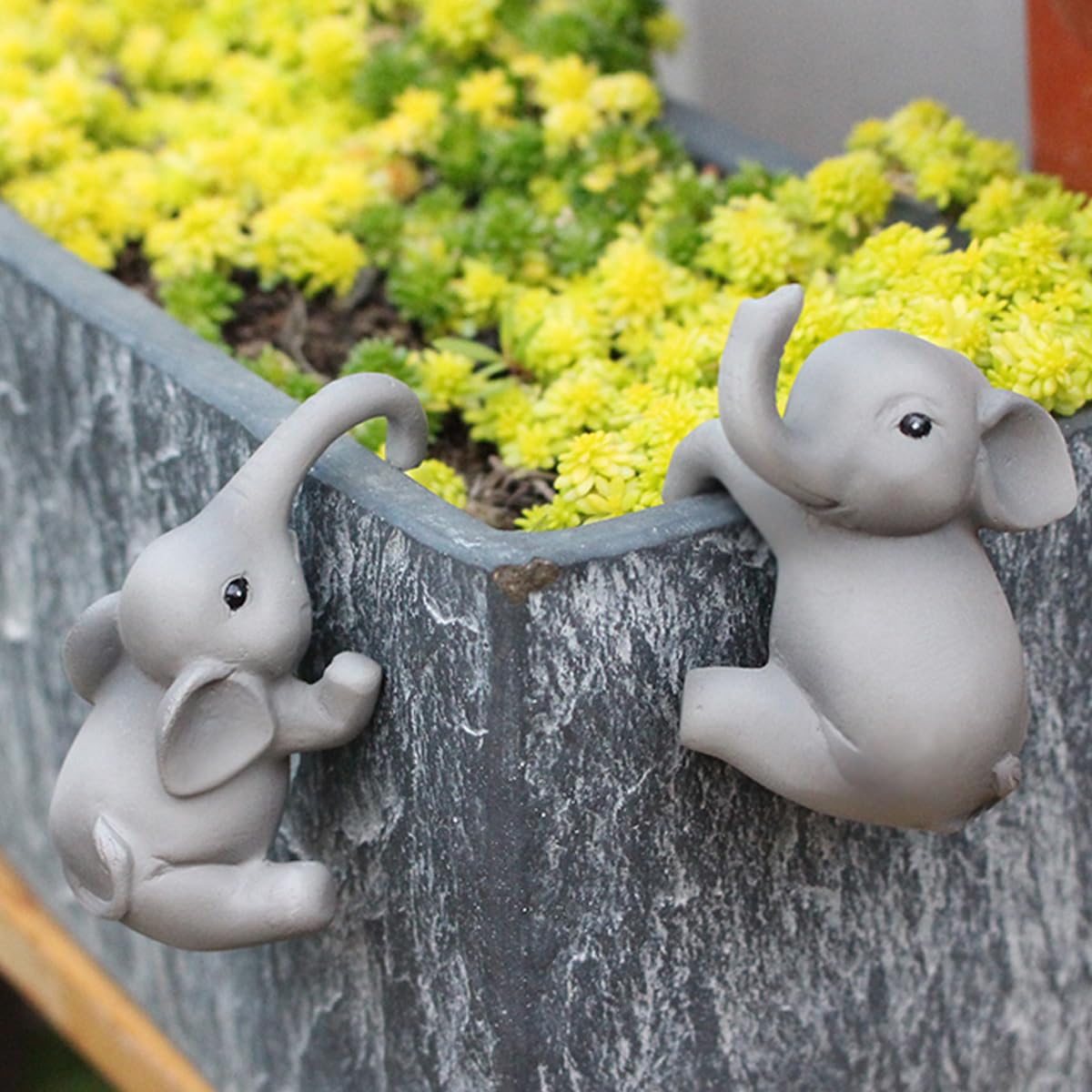 Pujipu elephant climbing figure pot hanger adds whimsical outdoor decor for small succulents.
