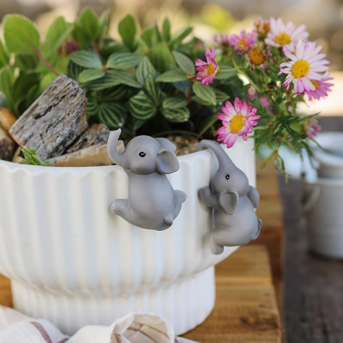 Pujipu funny pot huggers for planters brighten balconies with whimsy.