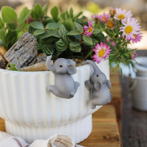 Pujipu funny pot huggers for planters brighten balconies with whimsy.