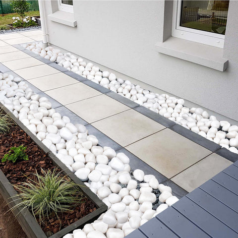 Pulovin drainage-friendly white rocks help soil drainage around planters.