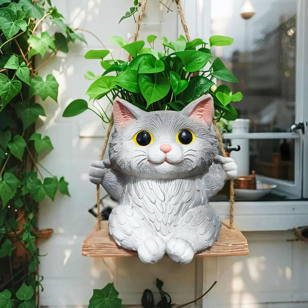 Pyoimmne cat hanging planter with adorable design, ideal for small succulents.