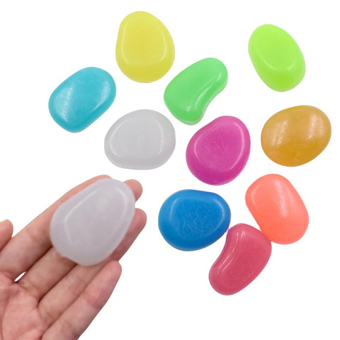QTTLLI glow pebbles in mixed colors illuminate a garden path at night