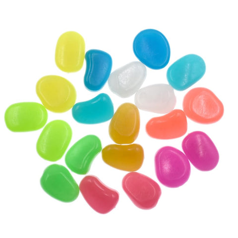 QTTLLI glow pebbles decorating an aquarium edge with soft glow