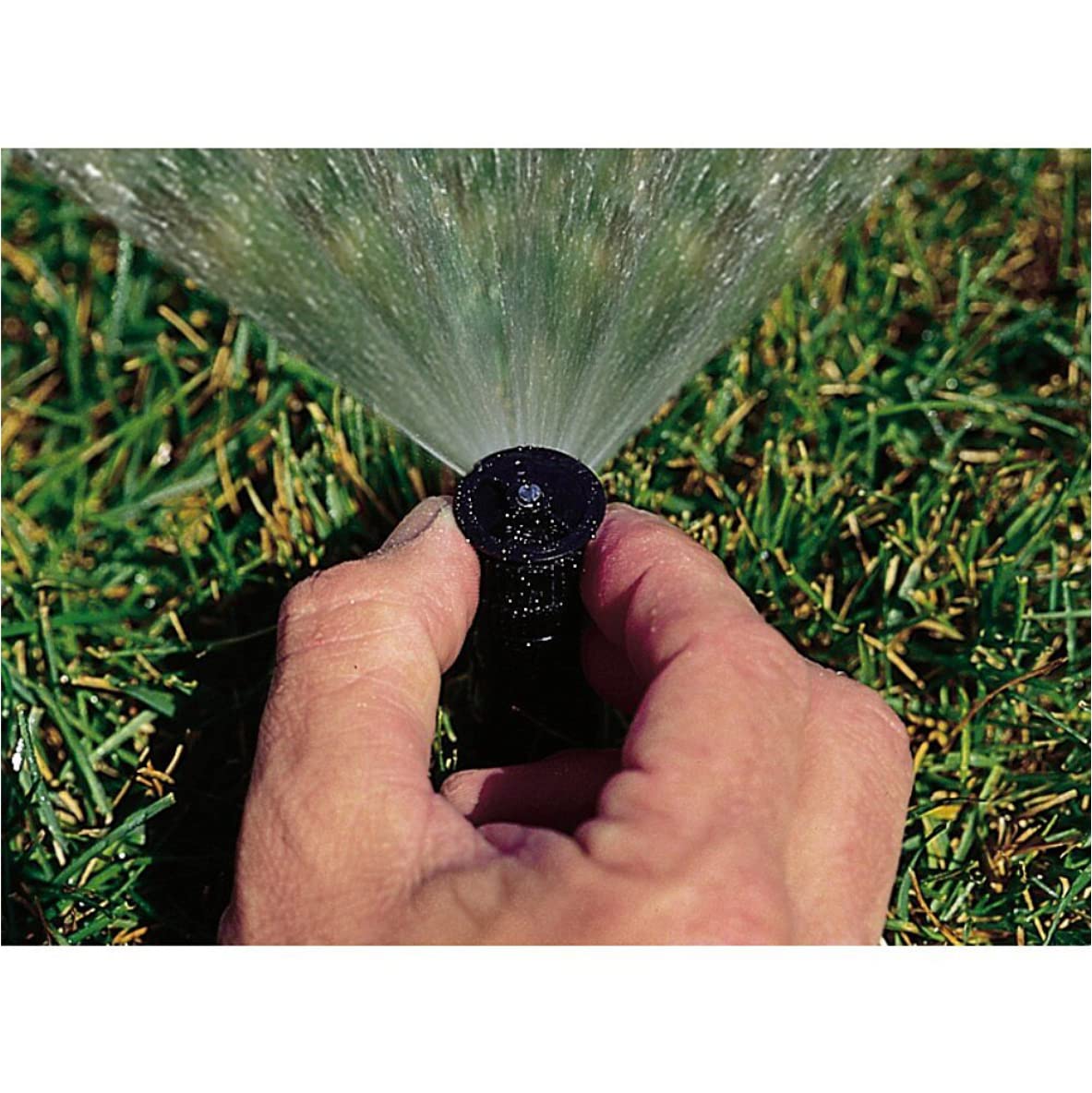 Rain Bird nozzle adjustment dial closeup highlighting easy pattern control for even coverage.