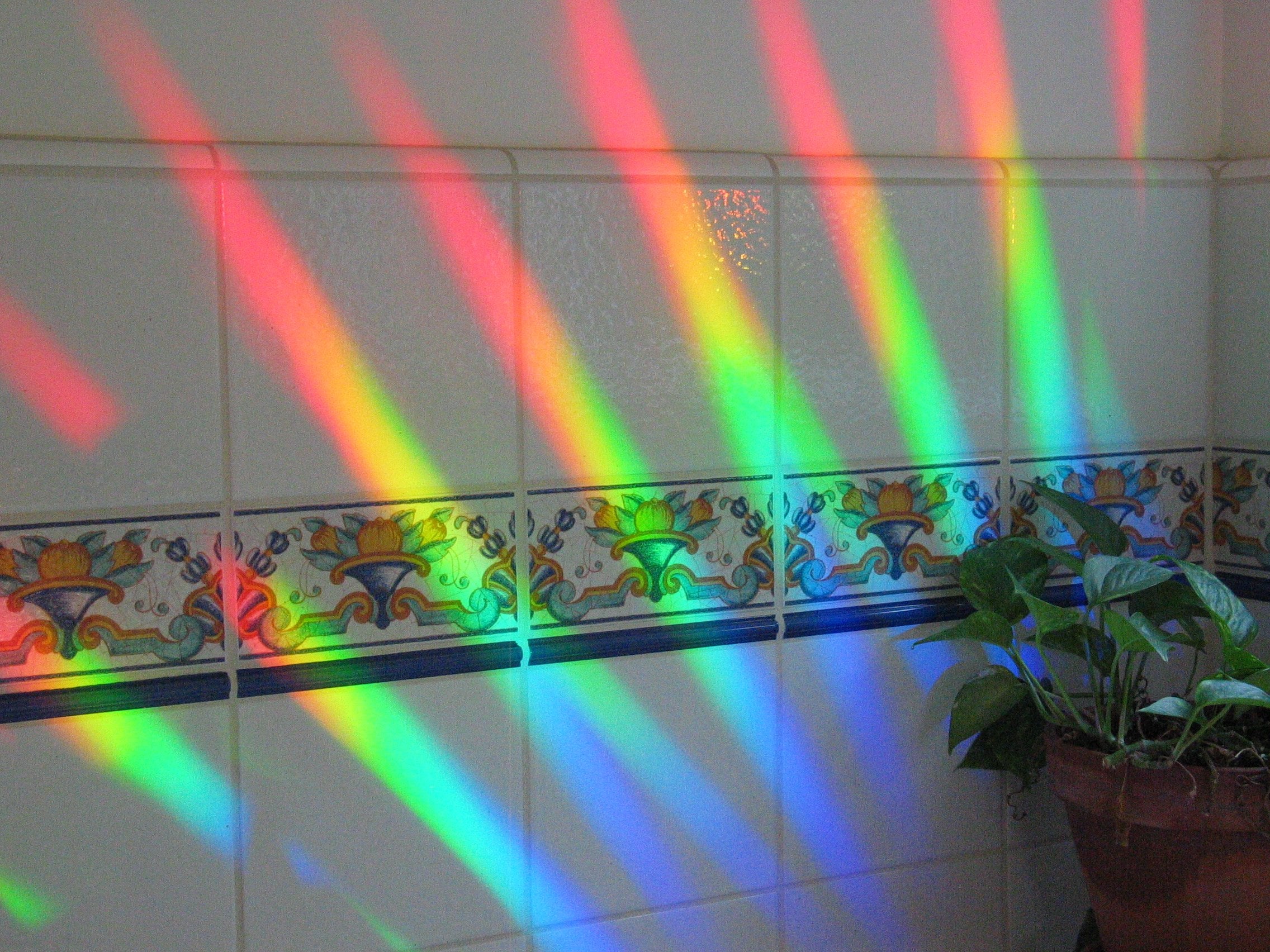 Rainbow Symphony hanging suncatcher with chrome frame adds versatile color accents in spaces.